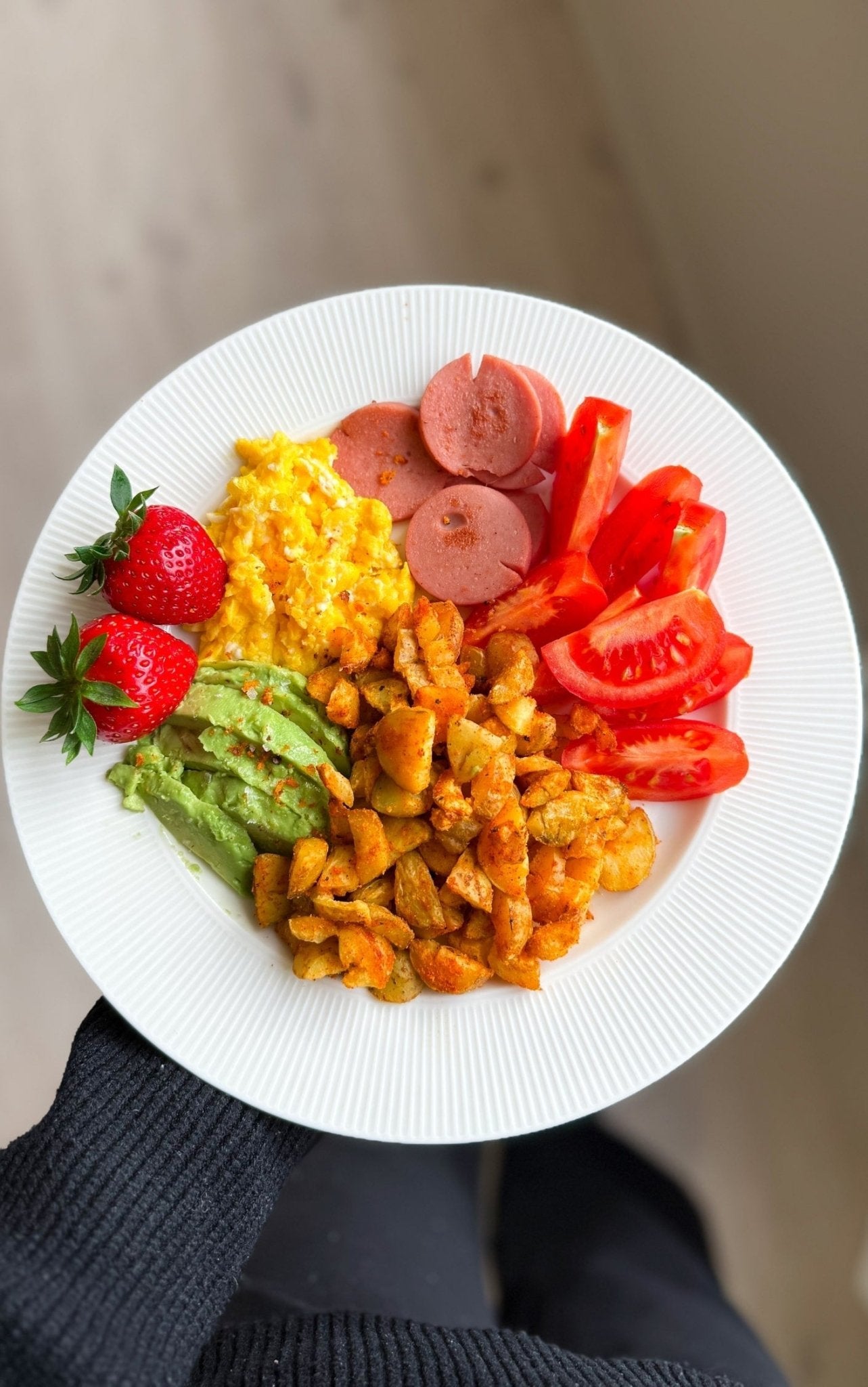 Nærbilde av en frisk og god frokost med stekte poteter, eggerøre, kalkunkorv og friske grønnsaker fra oppskrift i Kostholdsplan av Elena Mellingen.